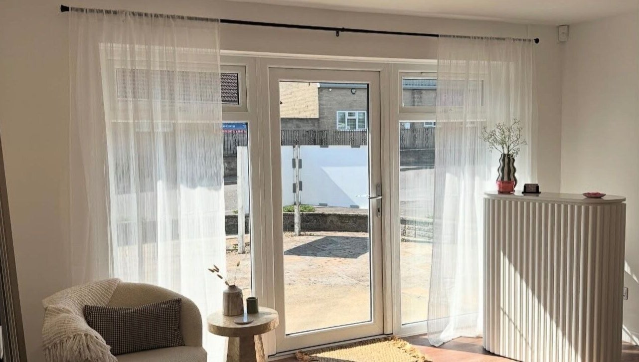 Bright and cozy seating area at Styled By Soph, Somerton, England, GB with natural light and minimalist decor.