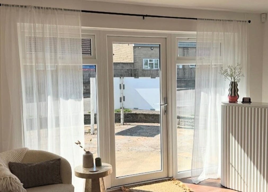 Bright and cozy seating area at Styled By Soph, Somerton, England, GB with natural light and minimalist decor.