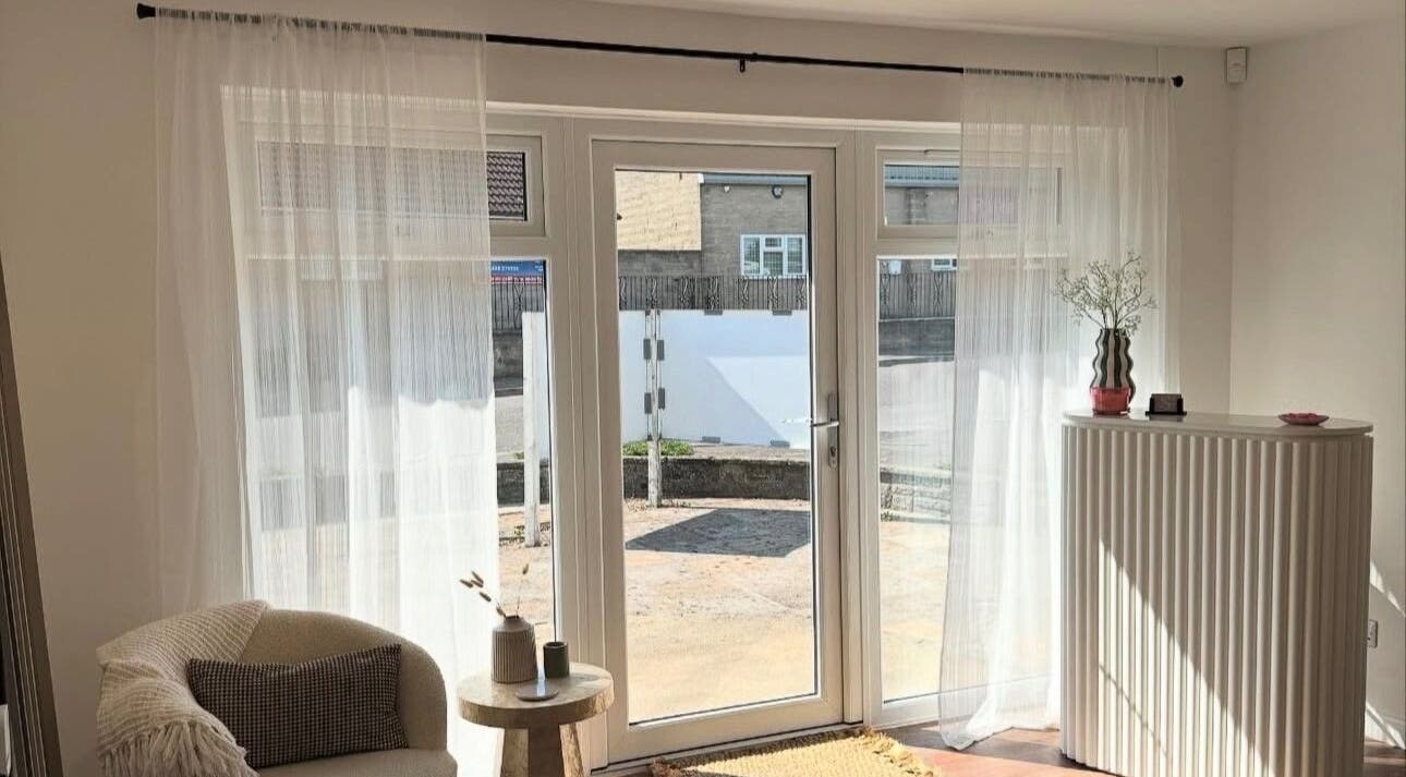 Bright and cozy seating area at Styled By Soph, Somerton, England, GB with natural light and minimalist decor.