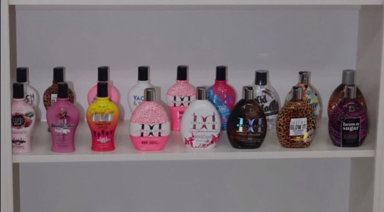 Luxe Soleil's vibrant tanning lotion selection in Yagoona, New South Wales, AU, displayed on a shelf.