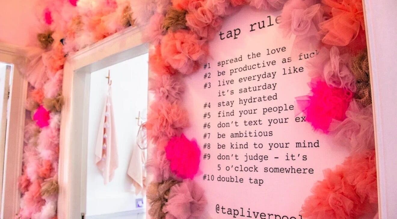 Colorful floral wall decor with inspirational text at Makeupbykian, Liverpool, England, GB.