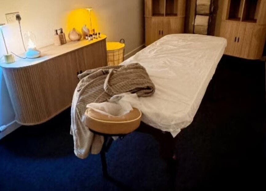 Relaxing treatment room at Oasis Body Studio, Peterhead, Scotland, GB, with massage table and warm lighting.