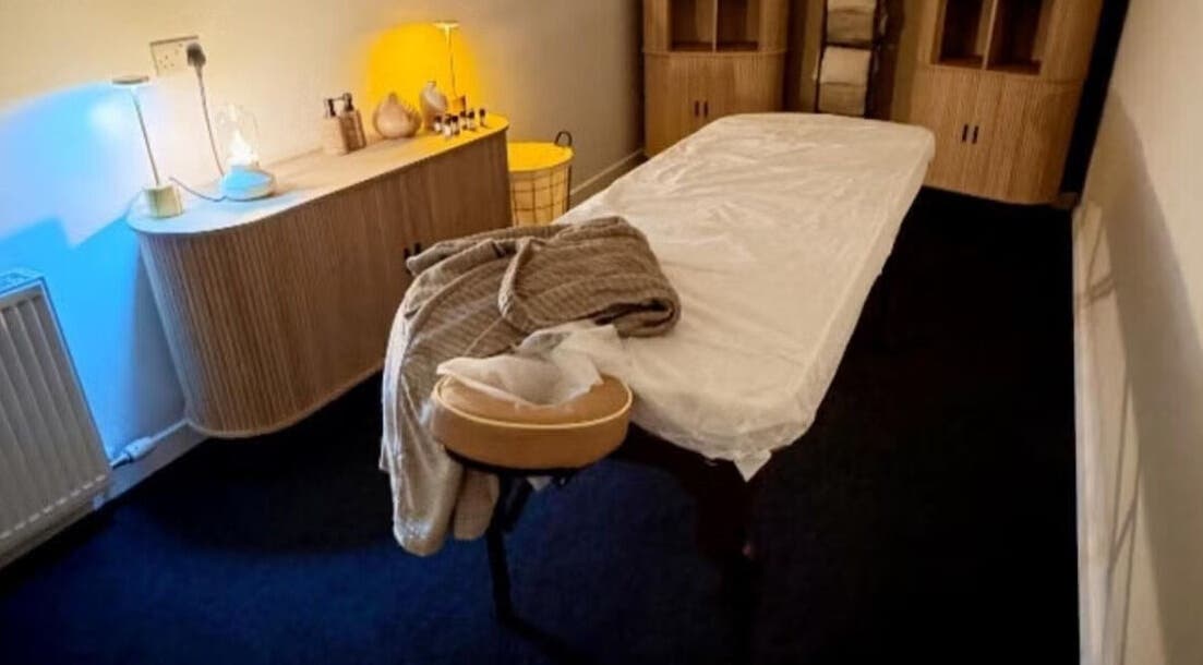 Relaxing treatment room at Oasis Body Studio, Peterhead, Scotland, GB, with massage table and warm lighting.