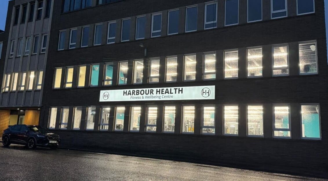 Exterior view of Oasis body studio in Peterhead, Scotland, showcasing bright windows.