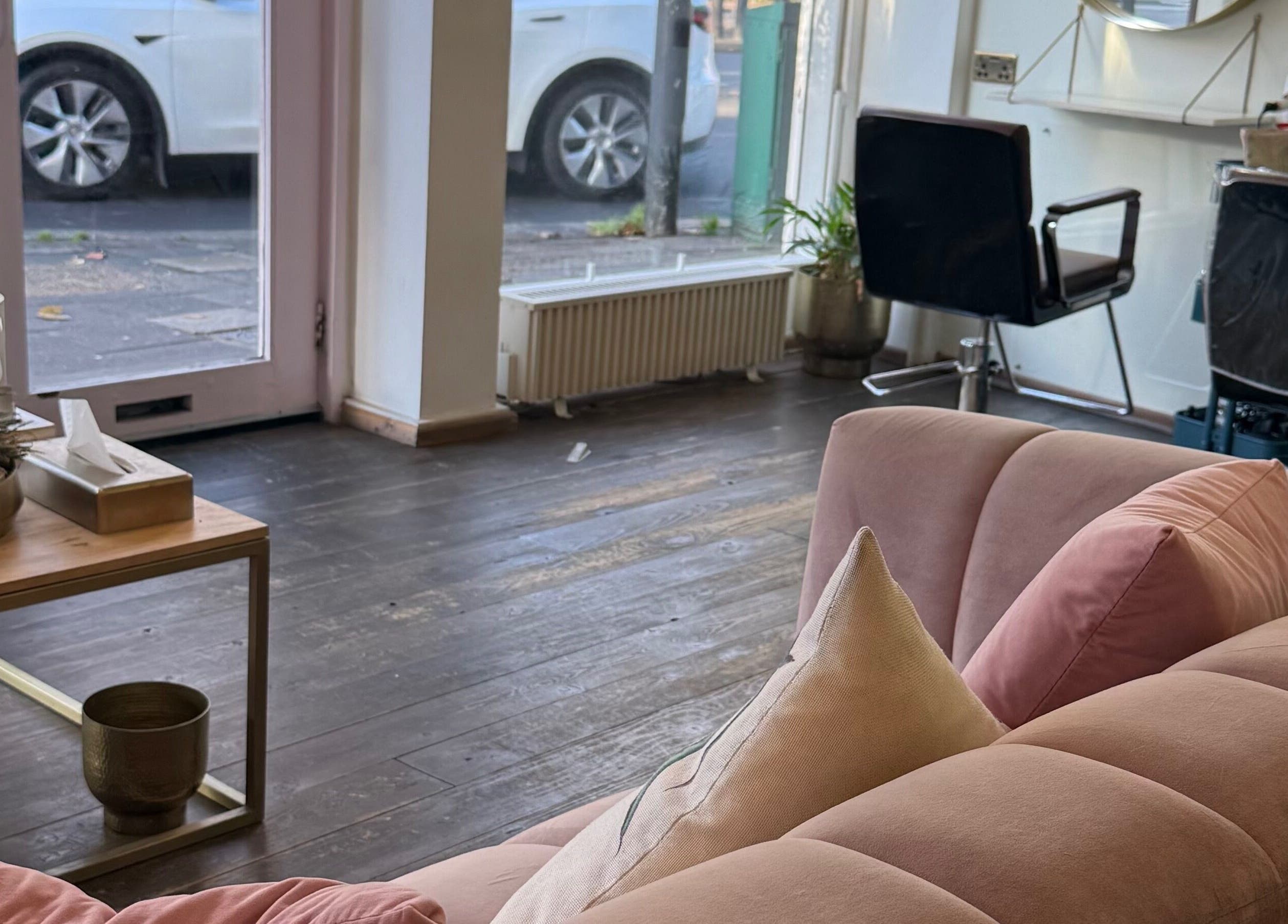 Cozy interior of Sara_Hair_blonde salon in London, England, GB with plush seating and stylish decor.
