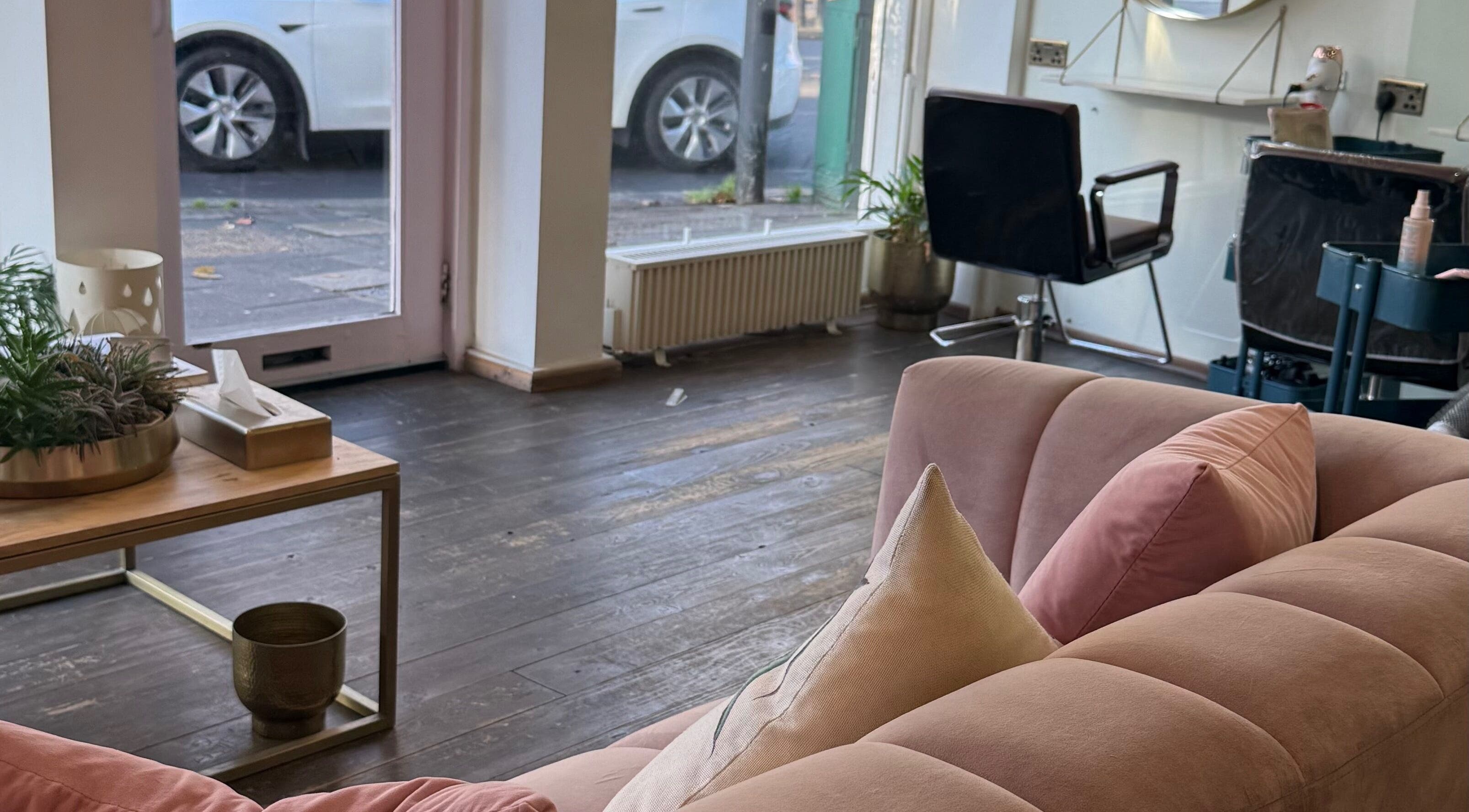Cozy interior of Sara_Hair_blonde salon in London, England, GB with plush seating and stylish decor.