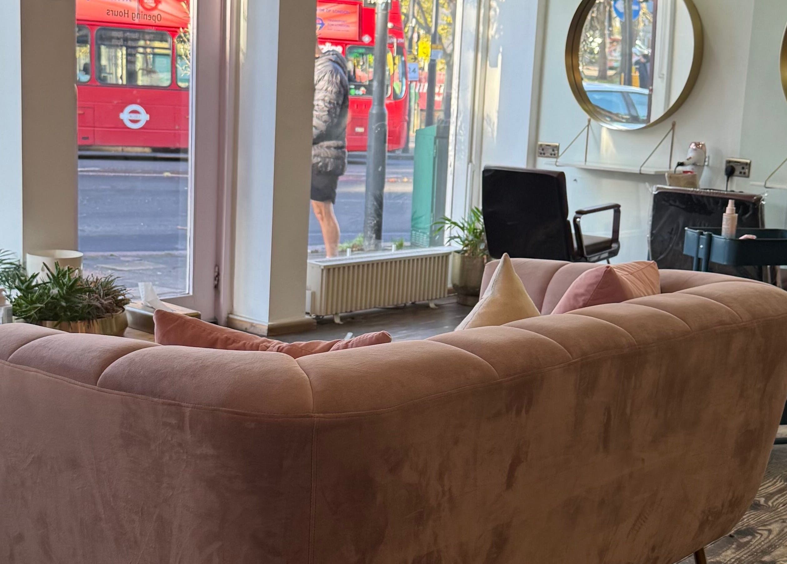 Chic interior of Sara_Hair_blonde salon in London, England, GB with plush seating and large mirrors.