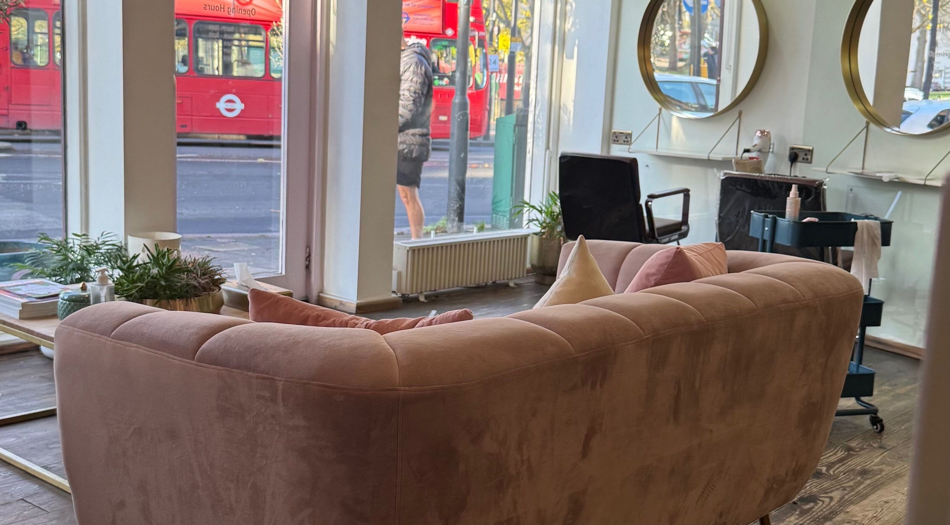 Chic interior of Sara_Hair_blonde salon in London, England, GB with plush seating and large mirrors.
