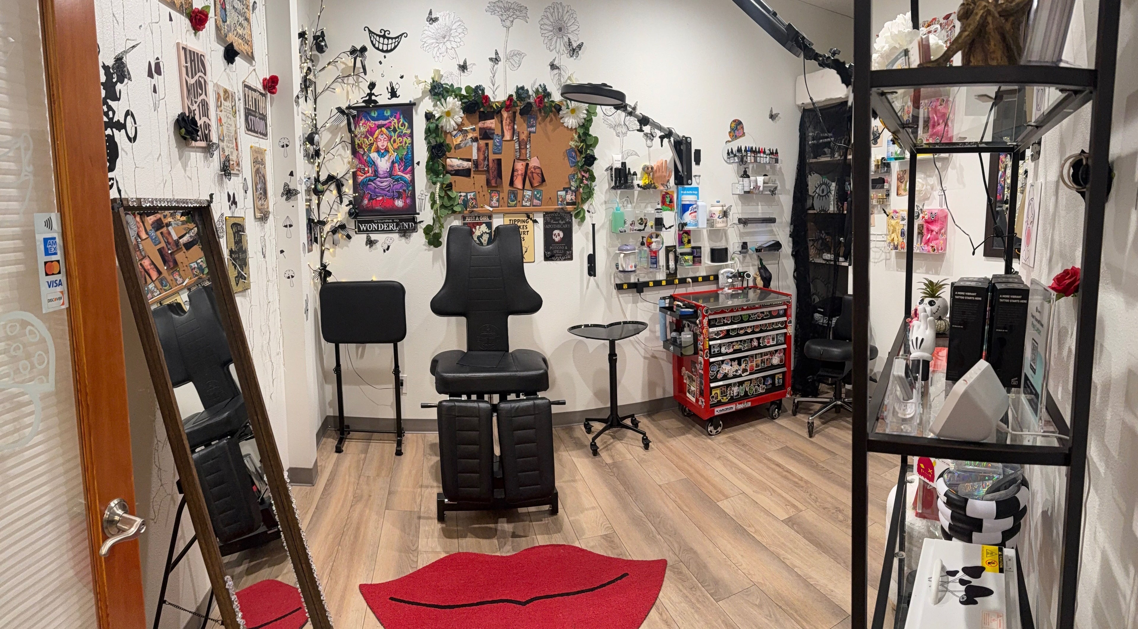 Interior of The Mad Tatter in Belfair, Washington showcasing a stylish tattoo station and decor.