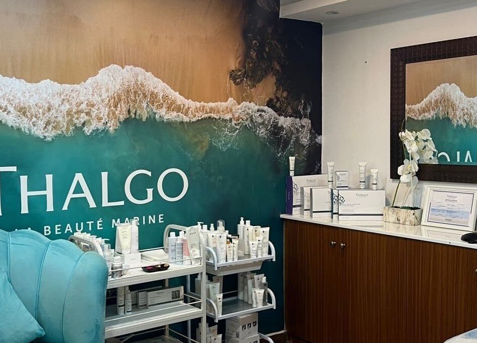 Thalgo products displayed at Du Monde Ladies Beauty Salon in Abu Dhabi, AE with a coastal mural backdrop.
