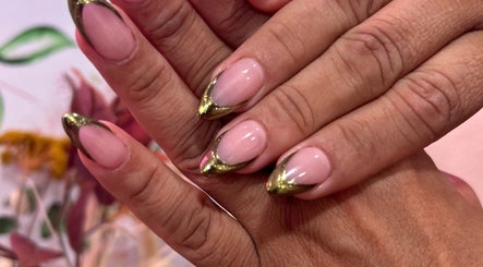 Elegant nail art with golden tips at Nailsbyflor, New York, New York, US, showcasing chic manicure designs.