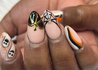 Halloween-themed nail designs by Nailsbyflor in New York, New York, US featuring spooky and elegant motifs.