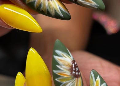 Elegant sunflower nail art at Nailsbyflor in New York, New York, US.