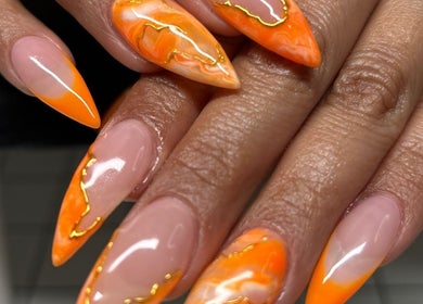 Vibrant orange nail art at Nailsbyflor in New York, New York, US captures bold elegance with an artistic touch.