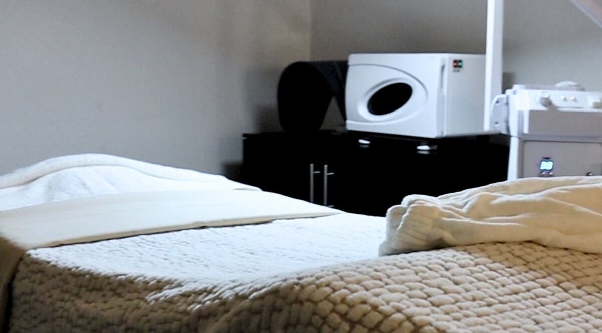 Cozy treatment room at Spa Clarity, Las Vegas, Nevada, US with plush bedding and warm lighting.