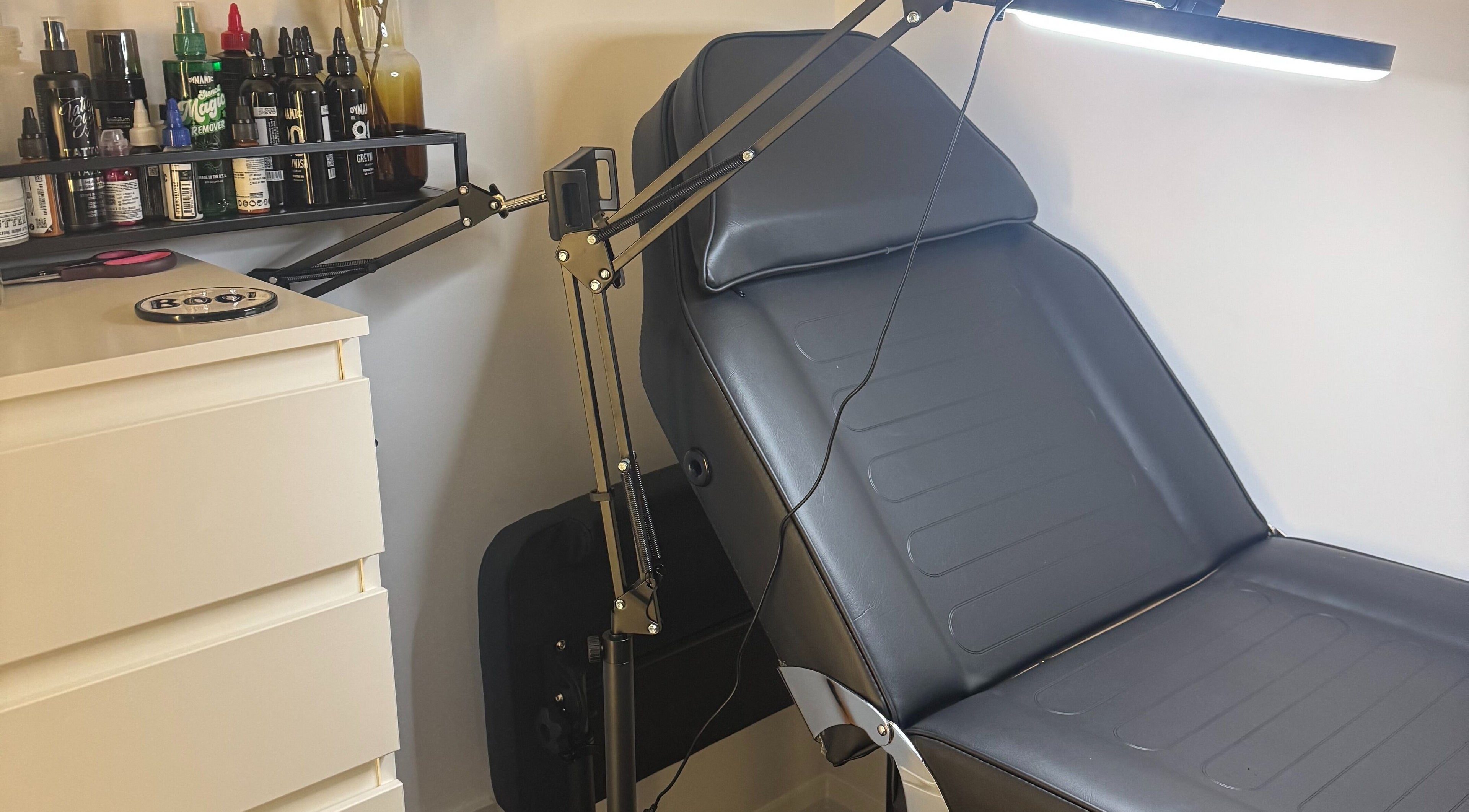 Morii Tattoos treatment chair with tools in Great Notley, England, GB, reflecting a clean studio.