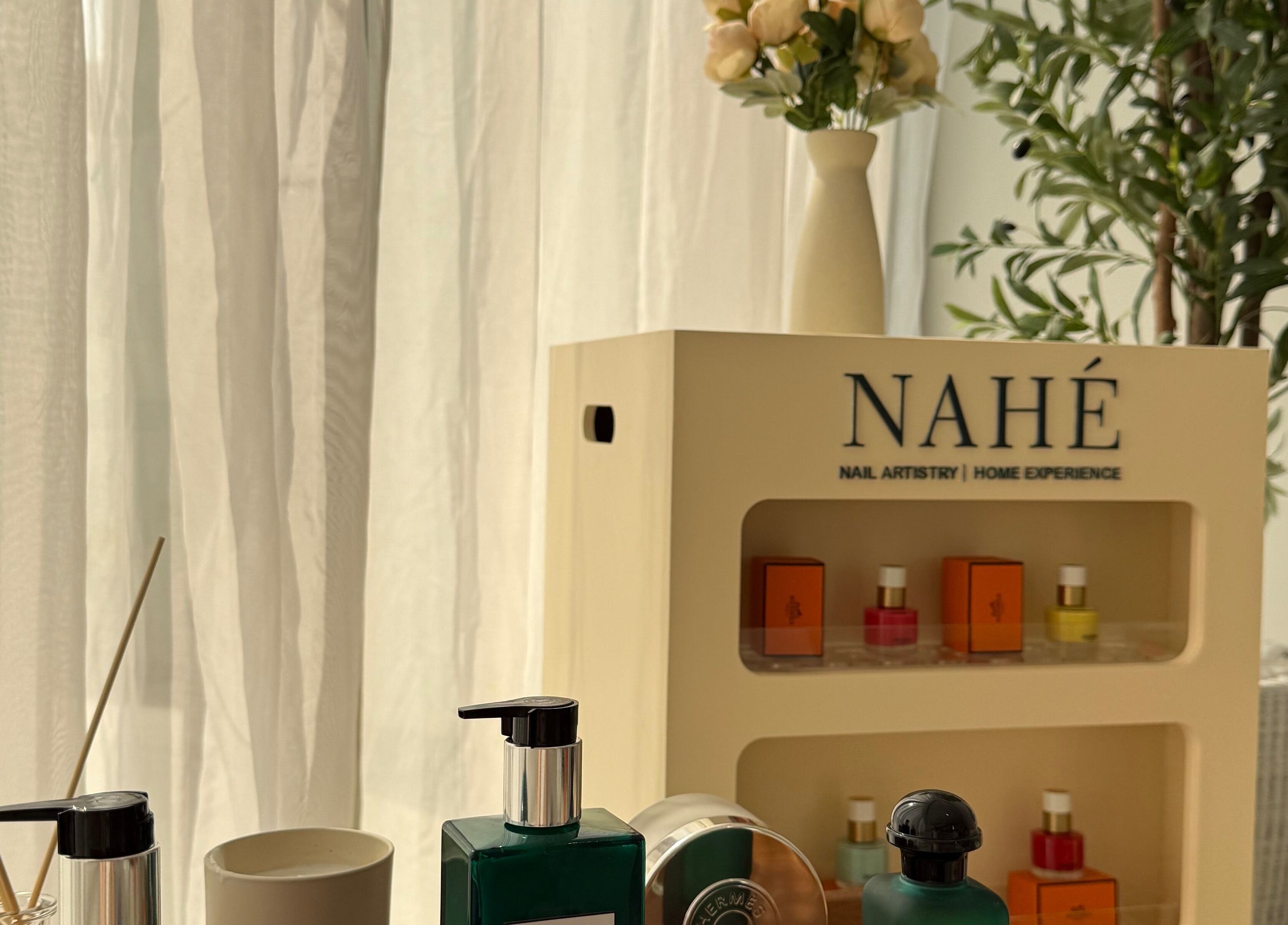Elegant display of beauty products at Nahé Beauty Home Service Salon, Dubai, AE, against a tranquil backdrop.