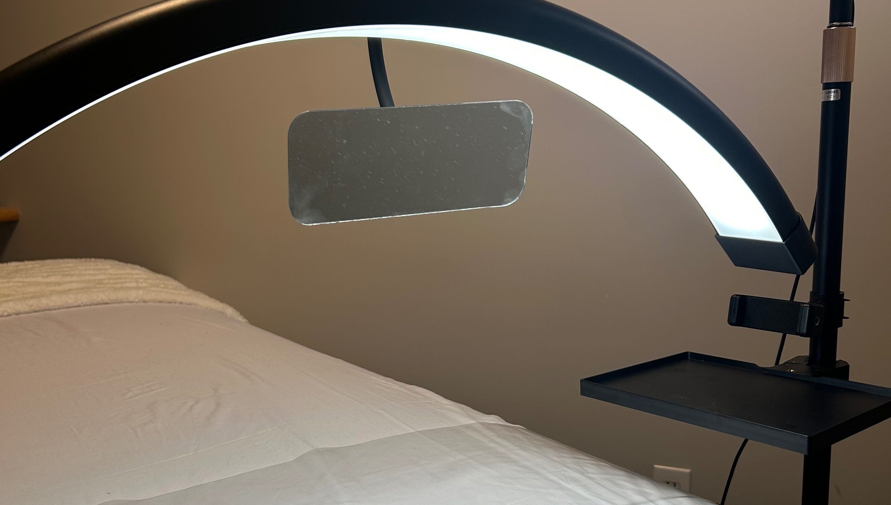 Relaxing treatment room at Advanced Beautique, Vaughan, Ontario, CA with modern lighting and a comfortable bed.