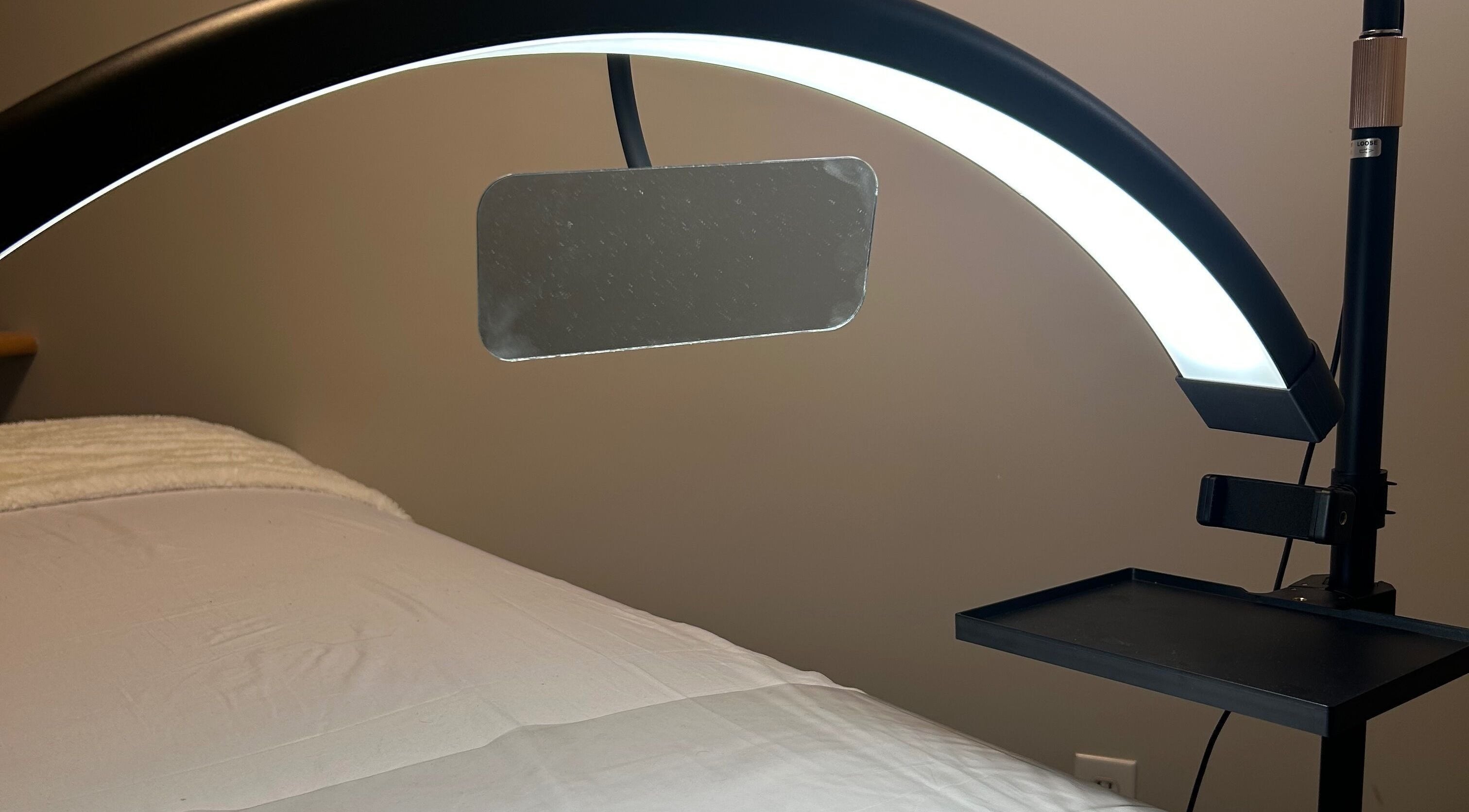 Relaxing treatment room at Advanced Beautique, Vaughan, Ontario, CA with modern lighting and a comfortable bed.