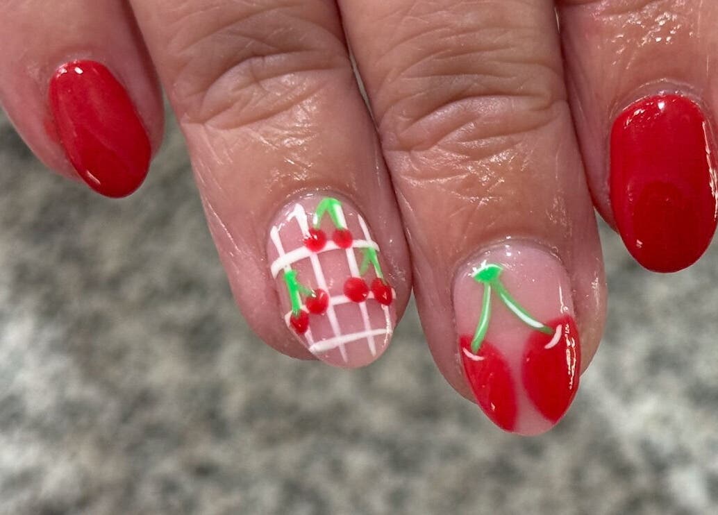 Cherry-themed nail art at Glimmer Nail Studio, Oshkosh, Wisconsin, US. Perfect for a chic and fresh look.