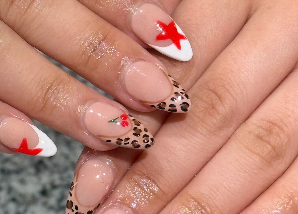 Stylish nail art with star and cheetah prints at Glimmer Nail Studio, Oshkosh, Wisconsin, US.