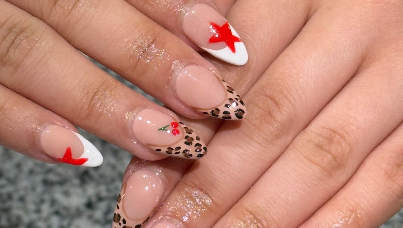 Stylish nail art with leopard and star design at Glimmer Nail Studio, Oshkosh, Wisconsin, US.