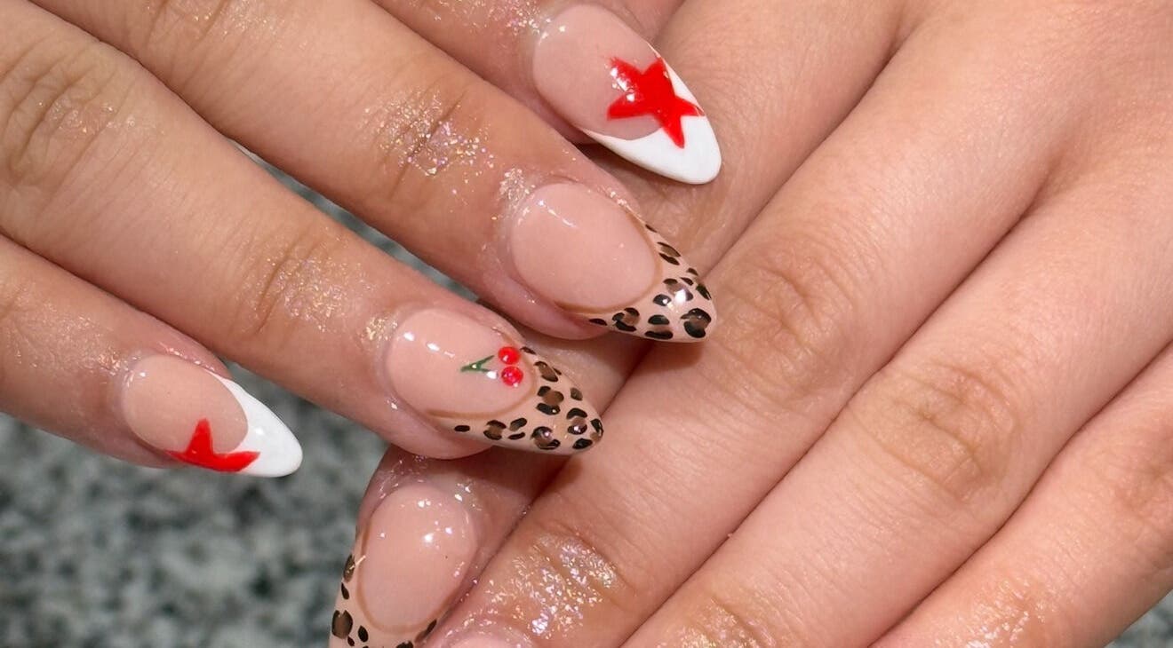 Stylish nail art with leopard and star design at Glimmer Nail Studio, Oshkosh, Wisconsin, US.
