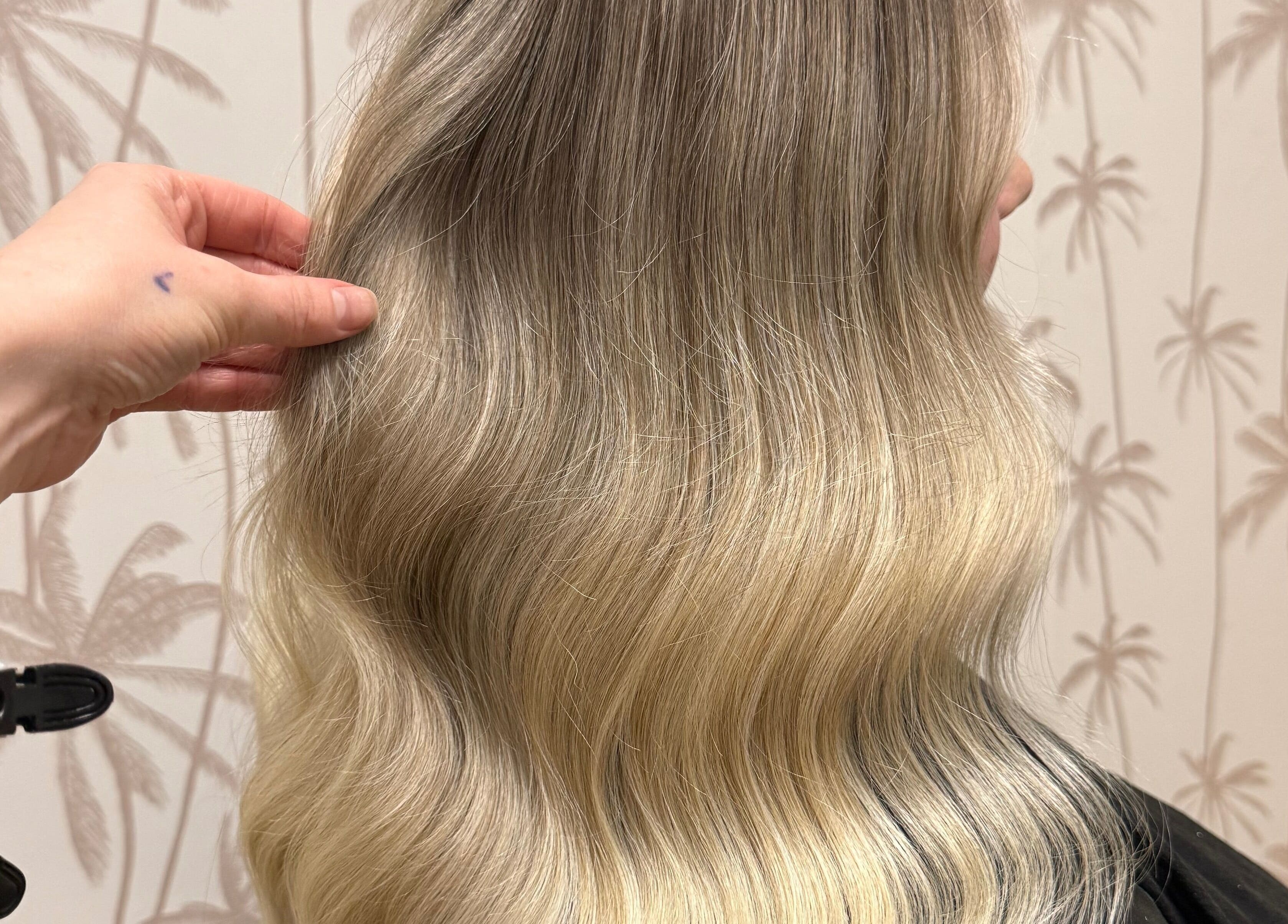 Stylish blonde hair styled at Hair by Liv Ralph, Warragul, Victoria, AU, showcasing smooth, wavy texture.
