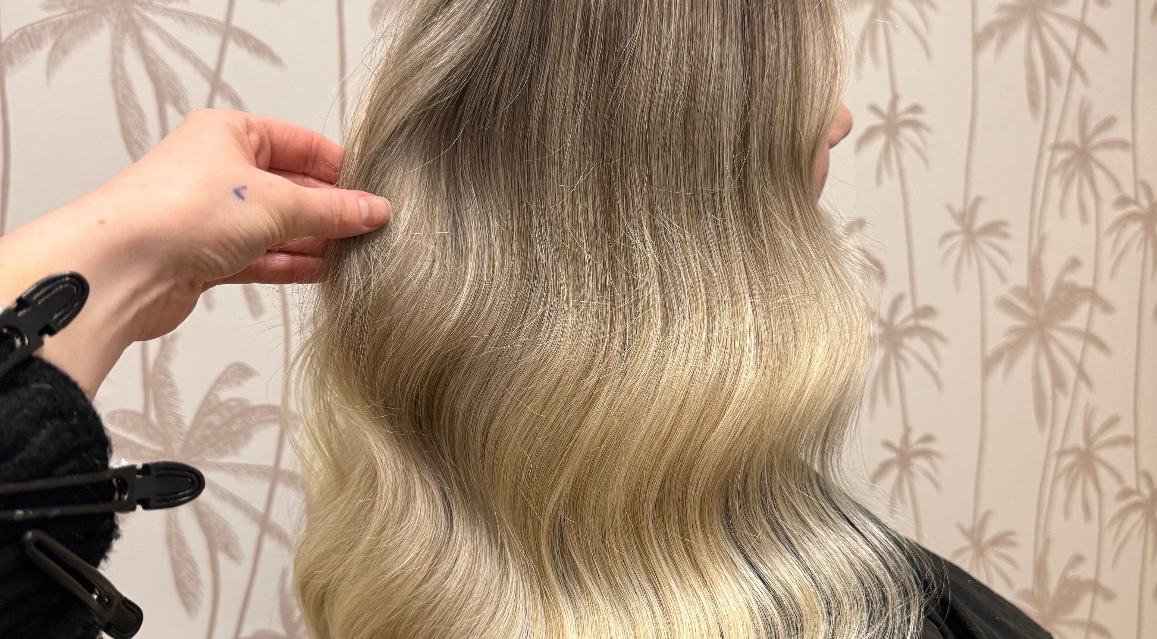 Stylish blonde hair styled at Hair by Liv Ralph, Warragul, Victoria, AU, showcasing smooth, wavy texture.