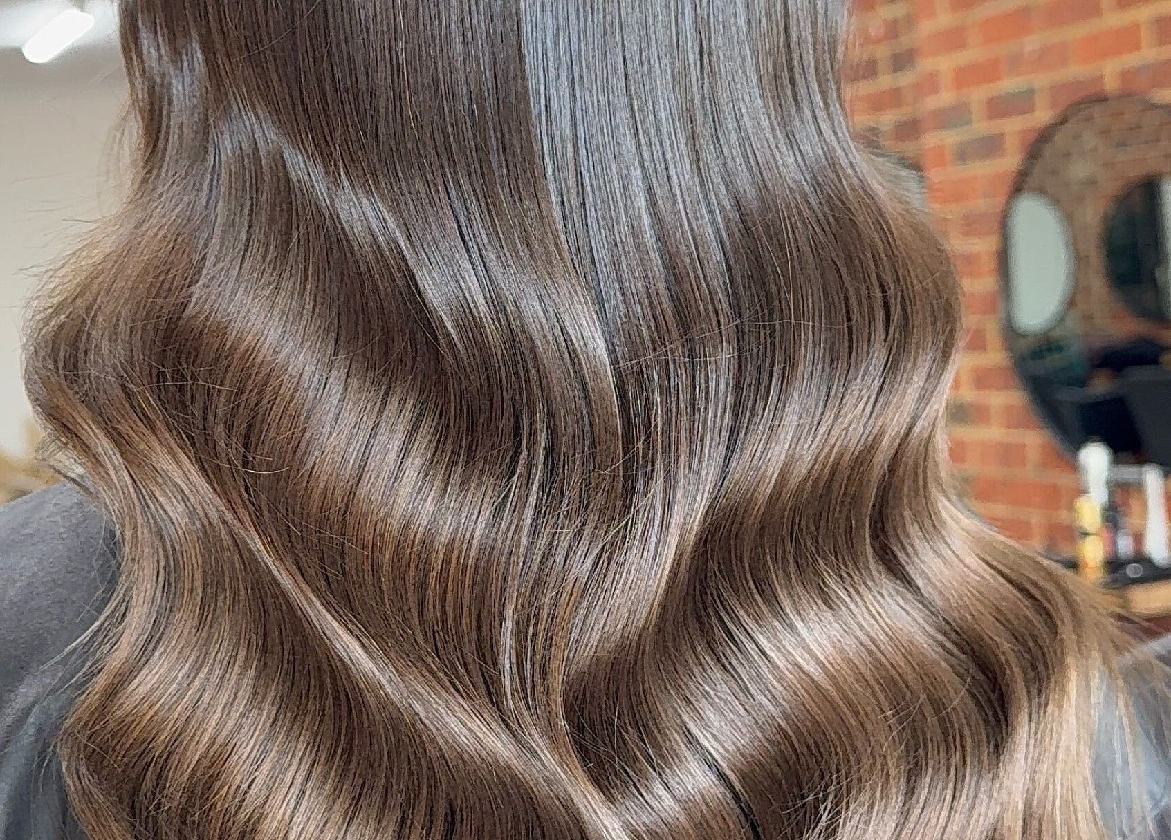 Sleek, wavy hairstyle at Hair by Liv Ralph, Warragul, Victoria, AU, showcasing expert hair treatment.