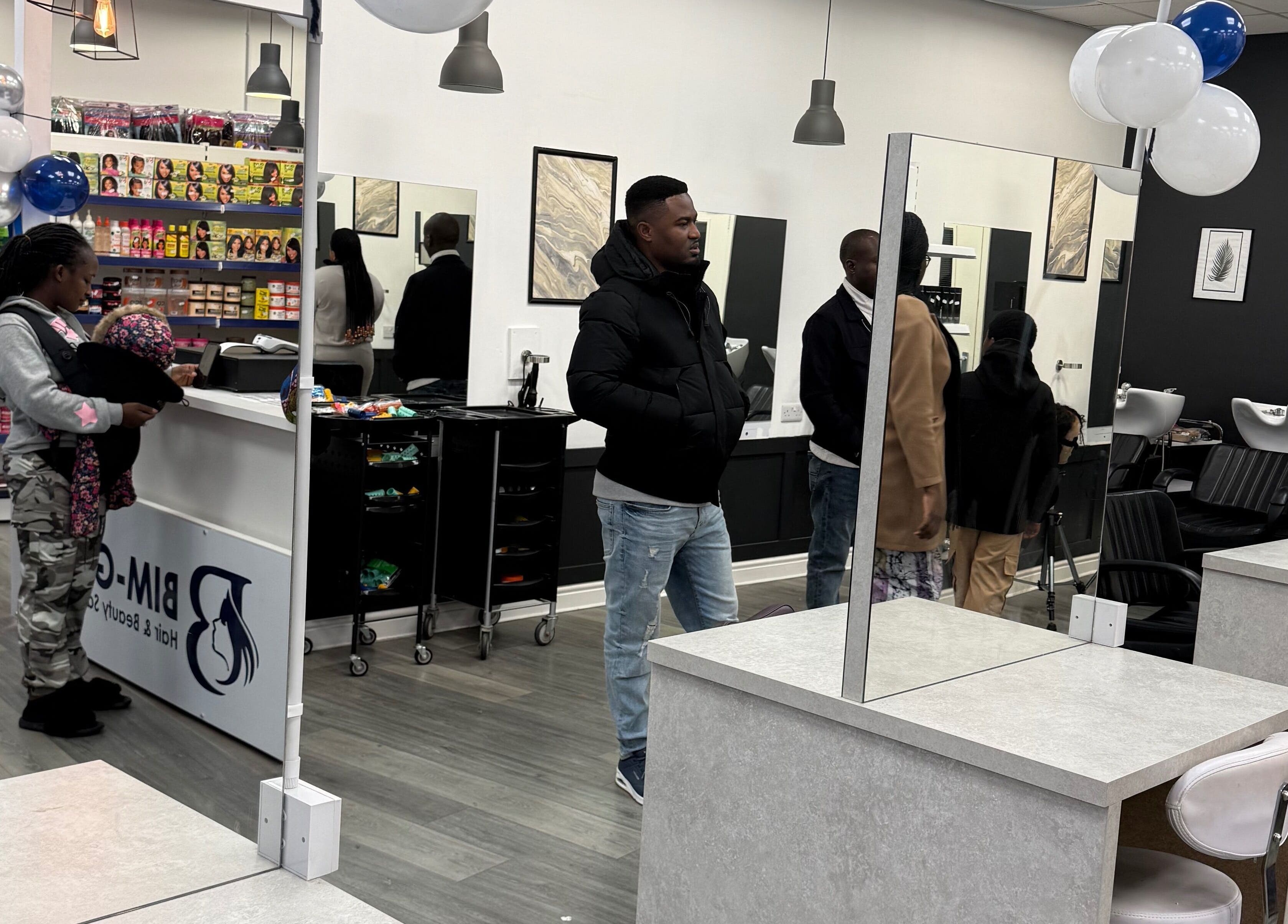 Inside Bim-Gold hair and beauty salon in Huddersfield, England, GB with customers and modern decor.