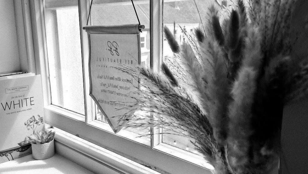 Cozy window decor at Chelsea Louise in Caistor, England, GB featuring pampas grass and books.