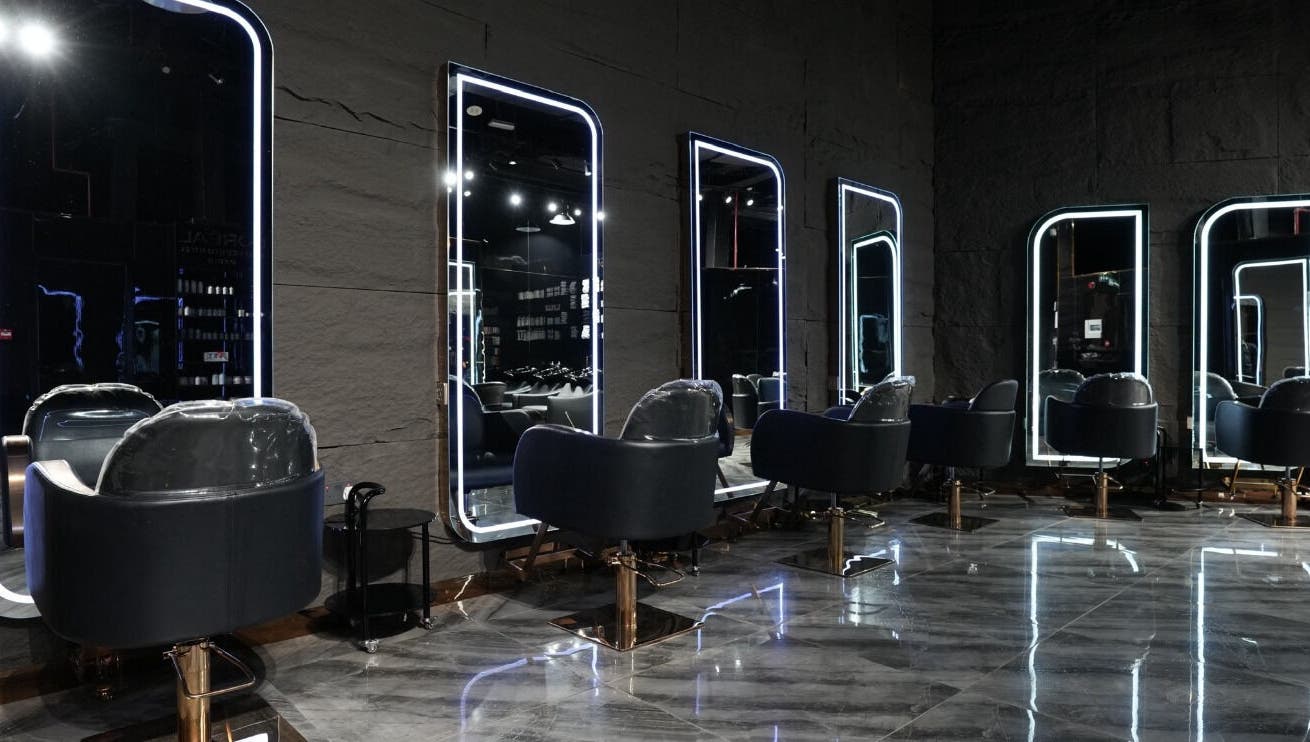 Modern salon chairs and mirrors at Dolche House Beauty Lounge, Dubai, AE, reflecting elegance and style.