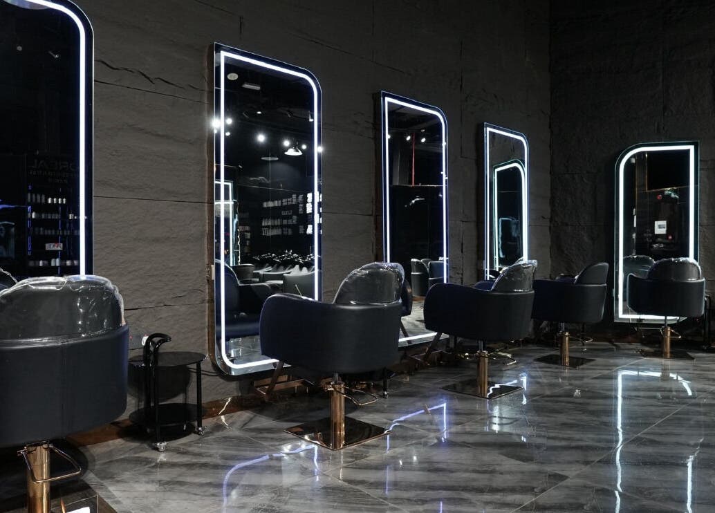 Modern salon chairs and mirrors at Dolche House Beauty Lounge, Dubai, AE, reflecting elegance and style.