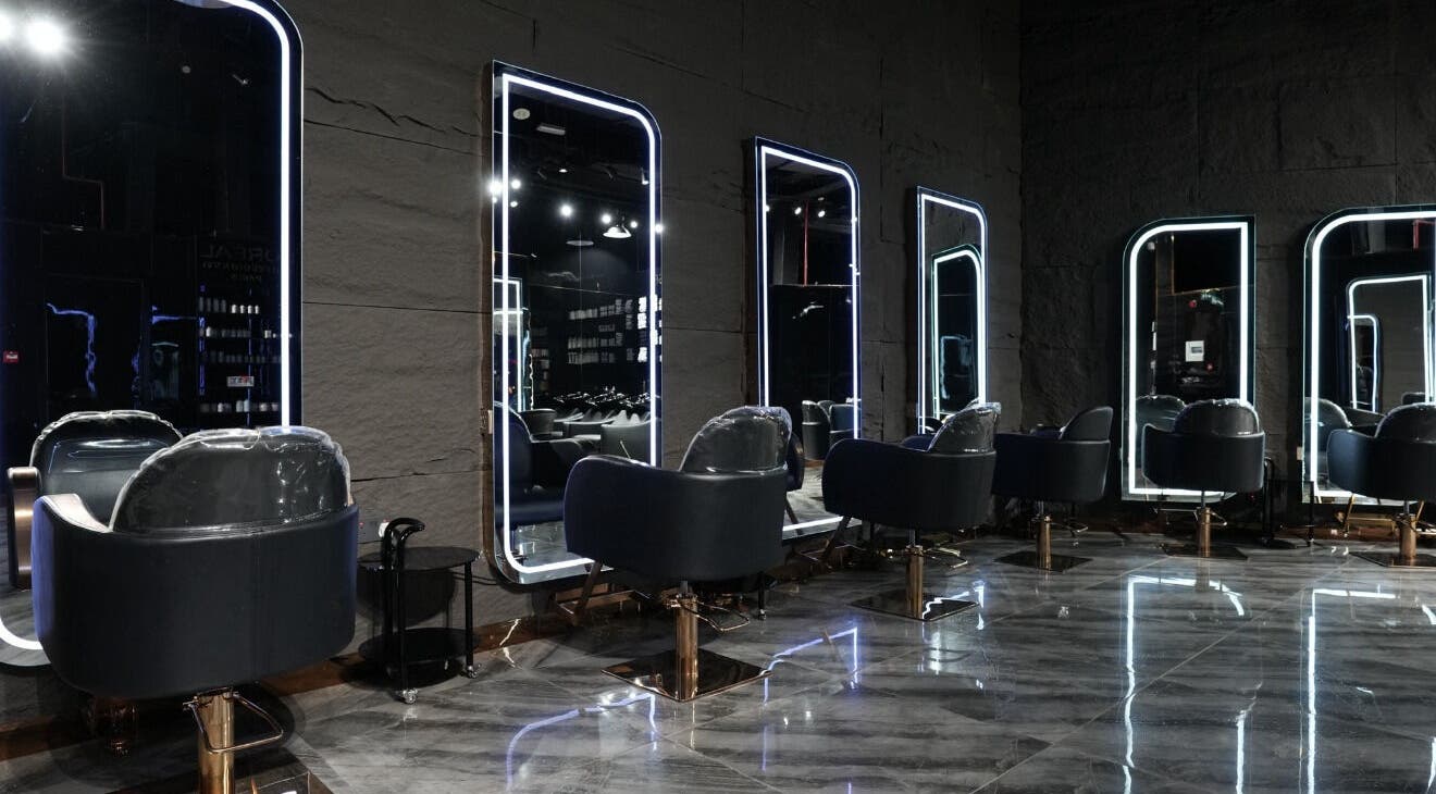 Modern salon chairs and mirrors at Dolche House Beauty Lounge, Dubai, AE, reflecting elegance and style.