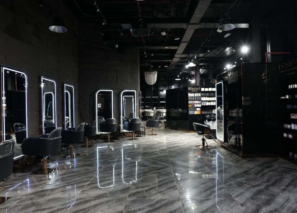 Chic interior of Dolche House Beauty Lounge, Dubai, AE with stylish chairs and mirrors.