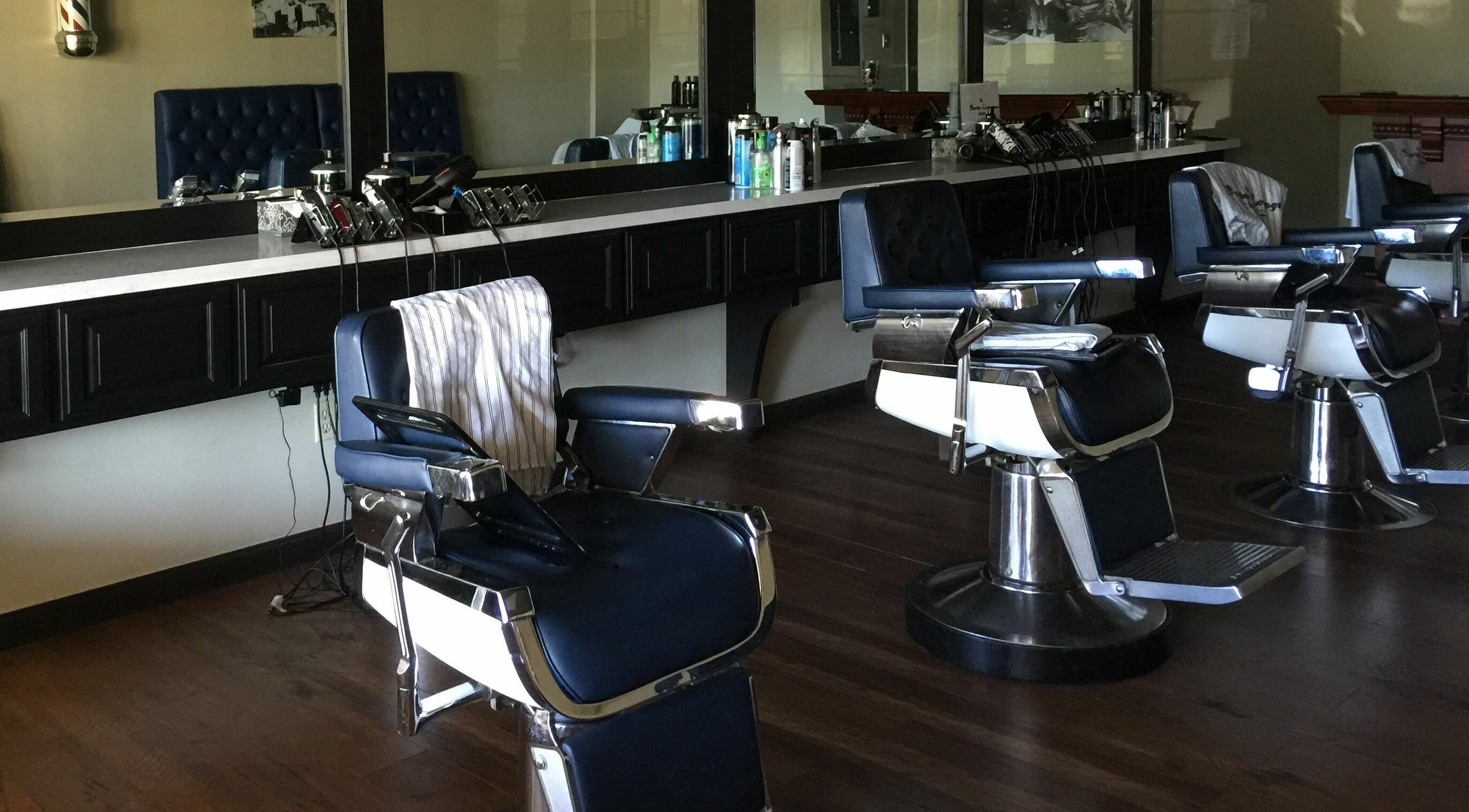 Barber chairs in The Barber Lounge, Folsom, California, US, showcasing sleek, modern design.
