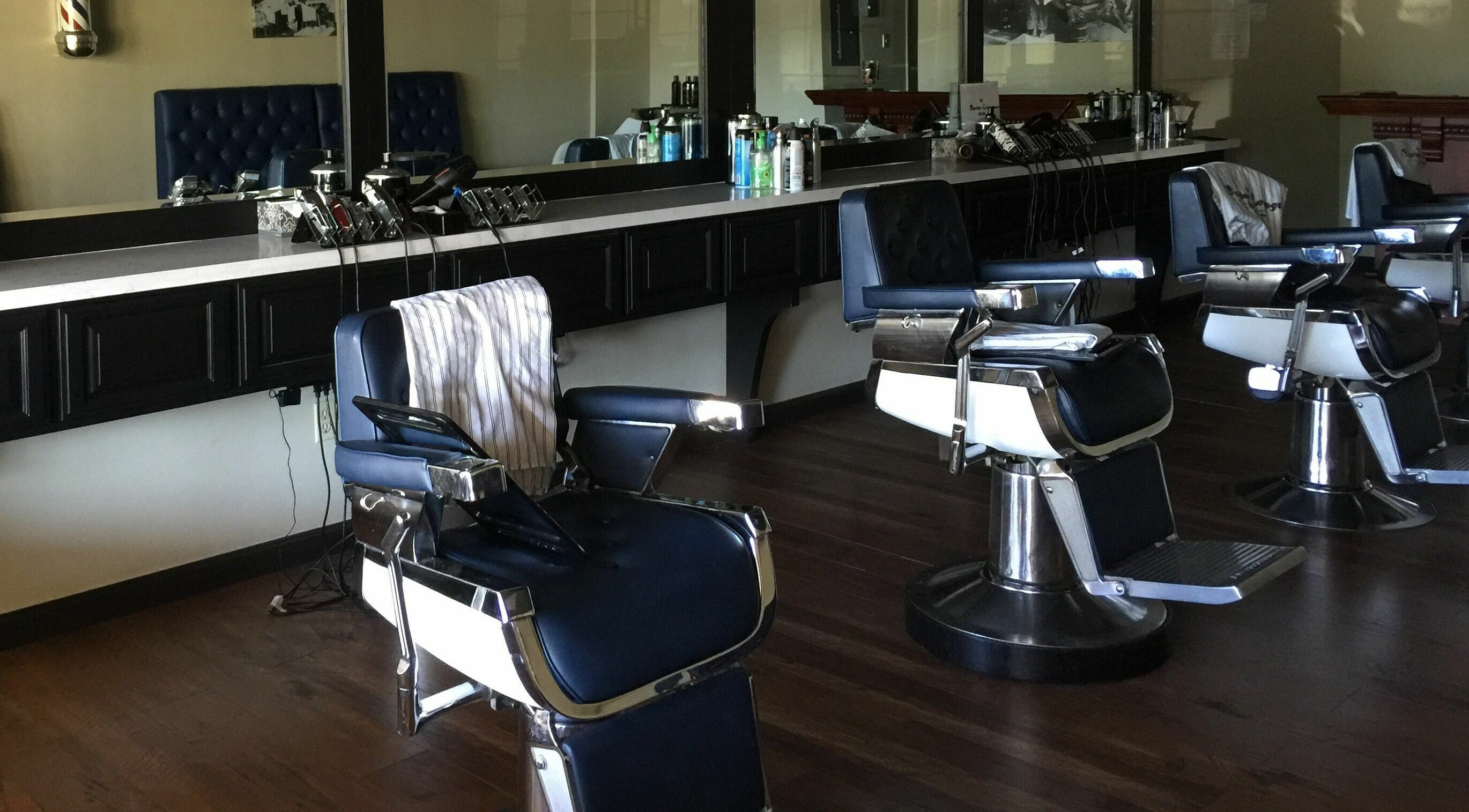 Barber chairs in The Barber Lounge, Folsom, California, US, showcasing sleek, modern design.