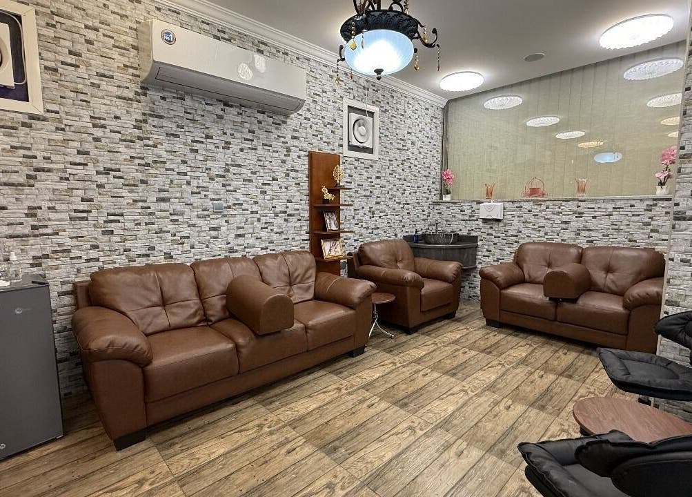 Comfortable lounge area at Rouge and Henna Beauty Saloon and Spa, Al Ain, Abu Dhabi, AE with brown leather sofas.