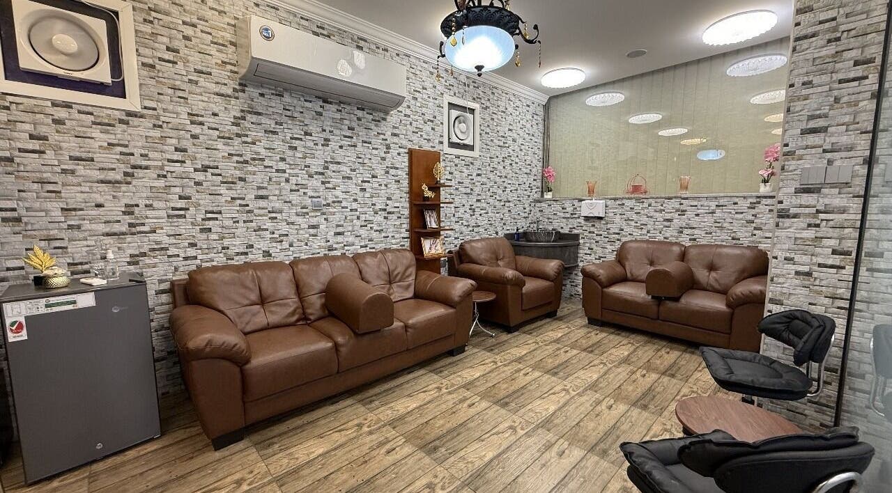 Comfortable lounge area at Rouge and Henna Beauty Saloon and Spa, Al Ain, Abu Dhabi, AE with brown leather sofas.