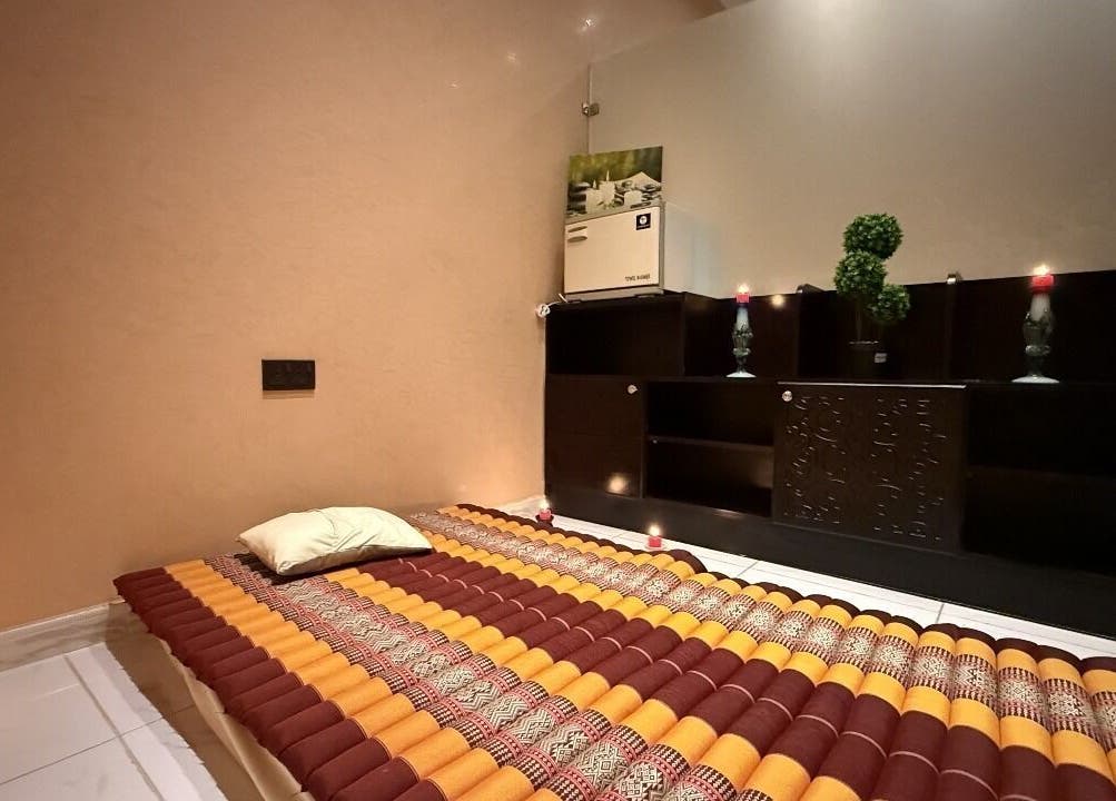 Relaxing massage room at Rouge and Henna Beauty Saloon and Spa, Al Ain, Abu Dhabi, AE, with soothing candles.