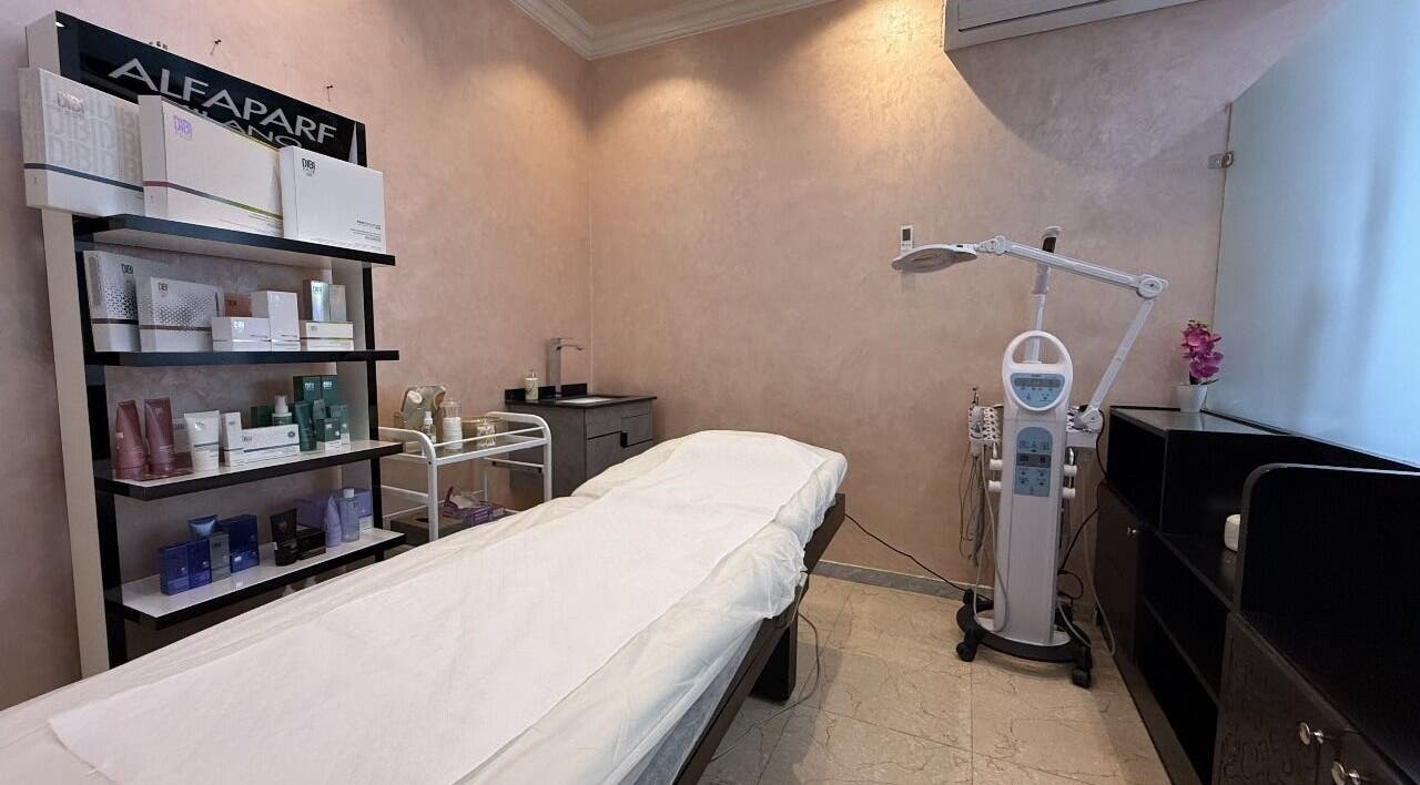 Treatment room at Rouge and Henna Beauty Saloon and Spa, Al Ain, Abu Dhabi, AE with massage bed and skincare products.
