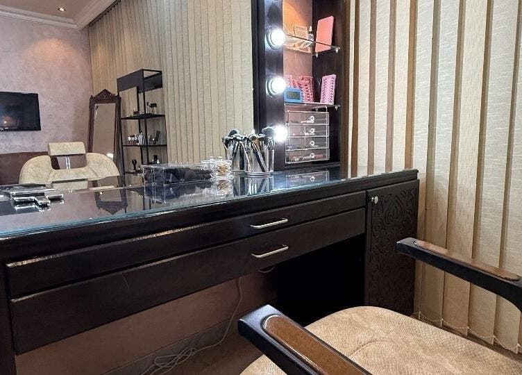 Elegant makeup station at Rouge and Henna Beauty Saloon and Spa, Al Ain, Abu Dhabi, AE, featuring chic decor.