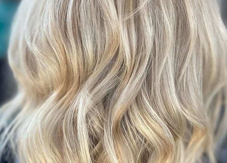 Blonde wavy hairstyle at Sophie Hair Artist, Thetford, England, GB, showcasing expert styling techniques.