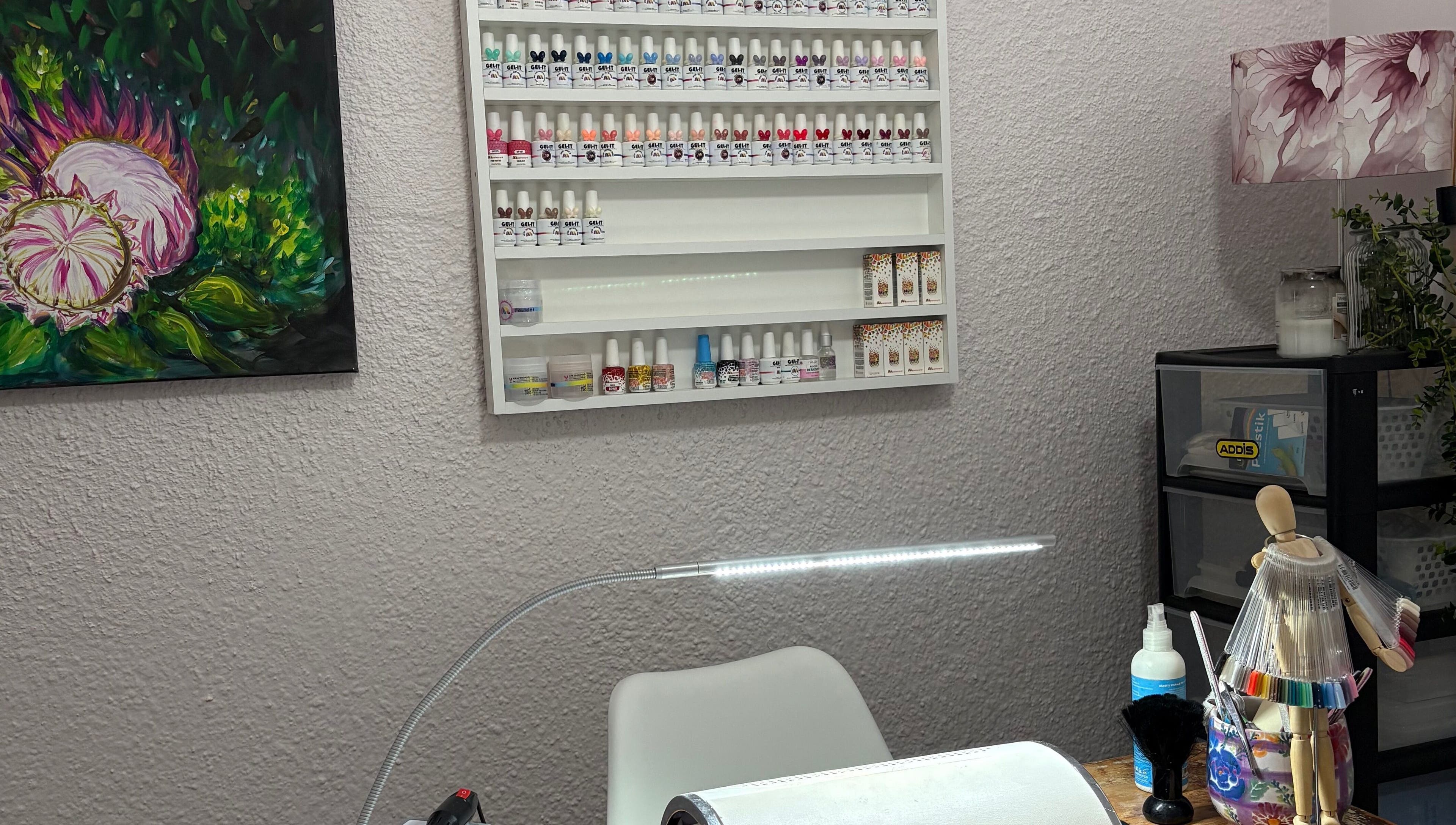 Cozy interior of 10Ten Nail Salon, Paarl, ZA with nail polish display and artistic decor.