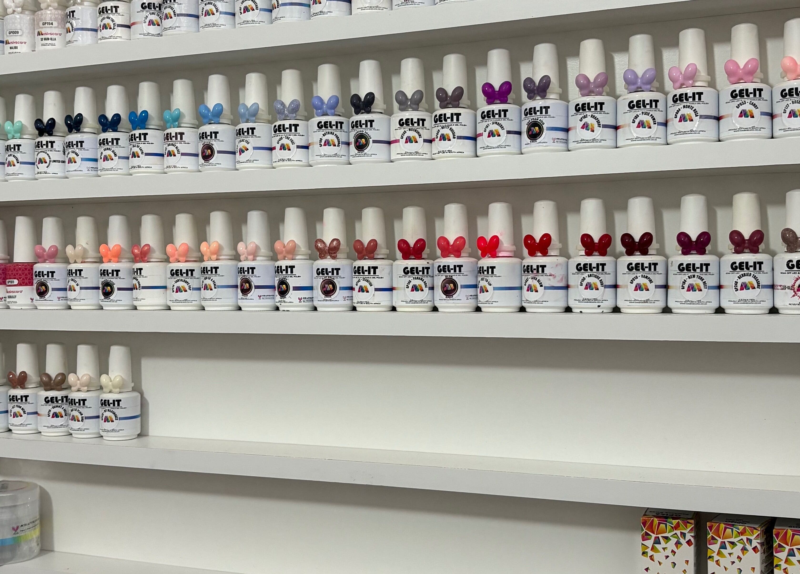 Colorful nail polish selection at 10Ten Nail Salon in Paarl, Western Cape, ZA showcasing various vibrant shades.