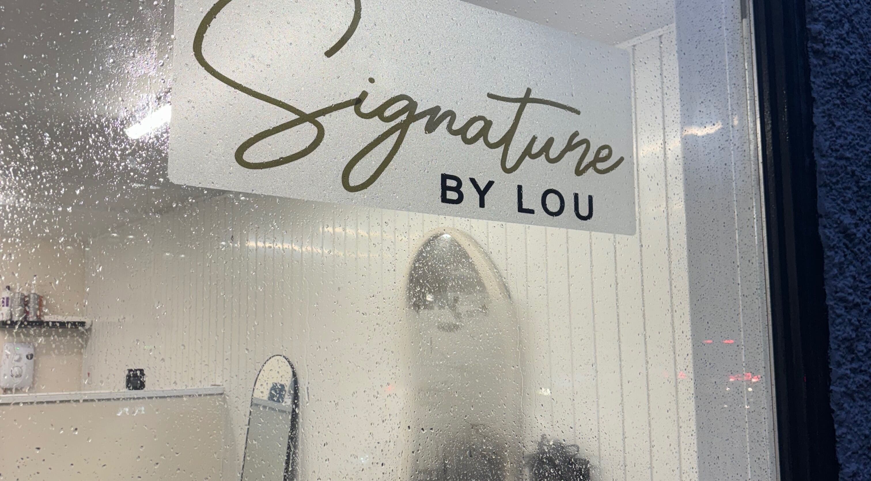 Rain-speckled window at Signature By Lou, Ilkeston, England, GB, showcasing its elegant interior.