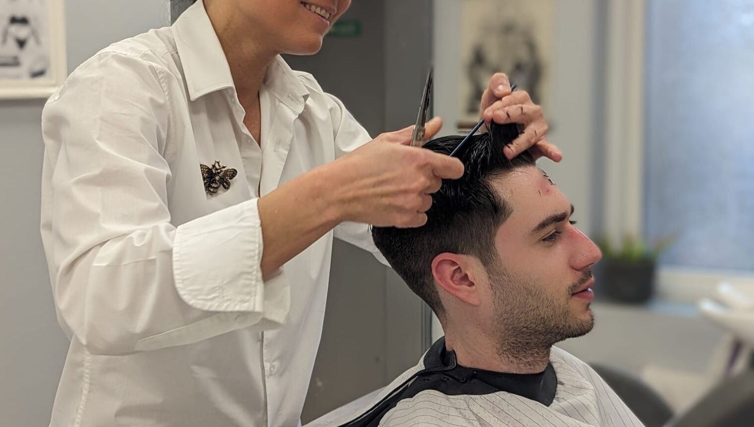 Hairdresser at Mila's head office in Bournemouth, England, GB giving a stylish haircut to a customer.