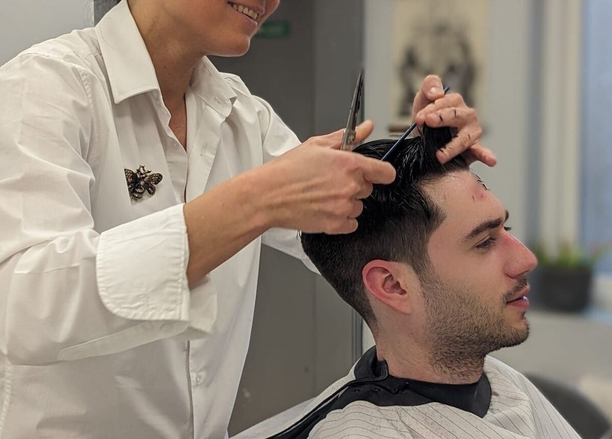 Hairdresser at Mila's head office in Bournemouth, England, GB giving a stylish haircut to a customer.