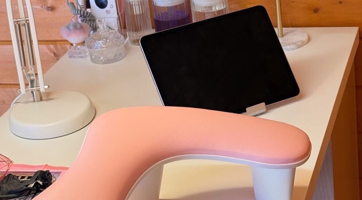 Modern nail station at GcsNails in Reading, England, GB with pink armrest and tablet setup.